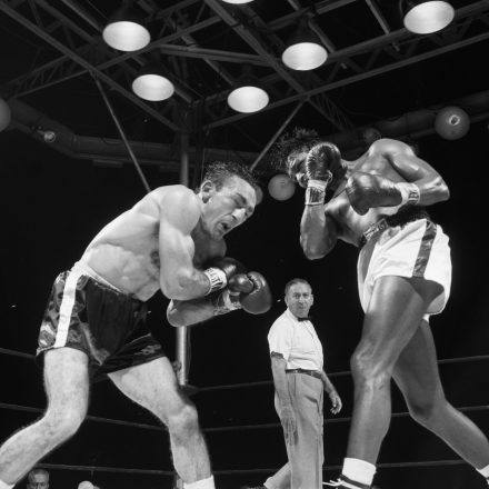 Two boxers in the ring in black and white.