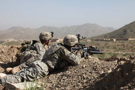 An image of two soldiers fighting in the war in Afghanistan