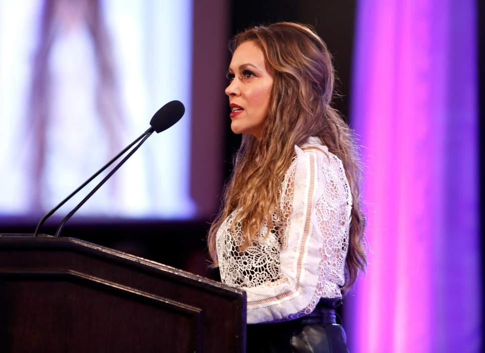 Alyssa Milano giving a speech at an awards show