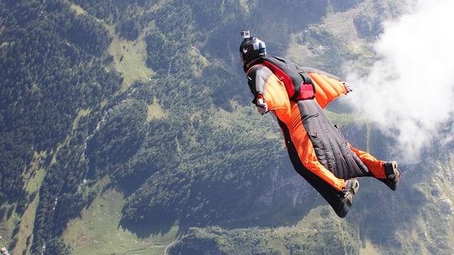 A photo of someone base jumping, which is known as one of the most extreme sports