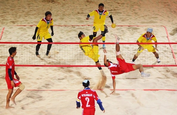 Sepak Takraw being played in a beach environment