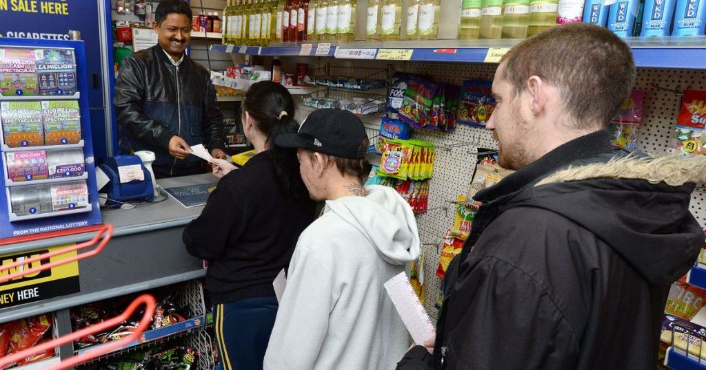 Punters buying lottery tickets at a shop with previous winners