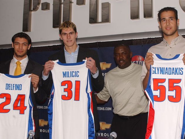 Darko Milicic posing with a Detroit Pistons jersey