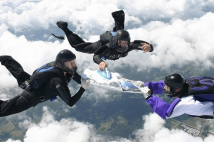Extreme Ironing taking place whilst people skydive