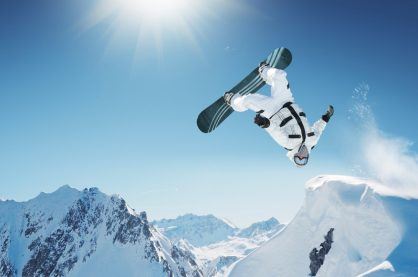 A snowboarder demonstrating a trick in this extreme sport