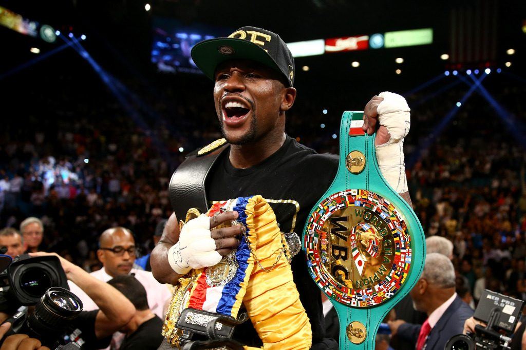 Floyd 'Money' Mayweather lifting a belt from a previous fight