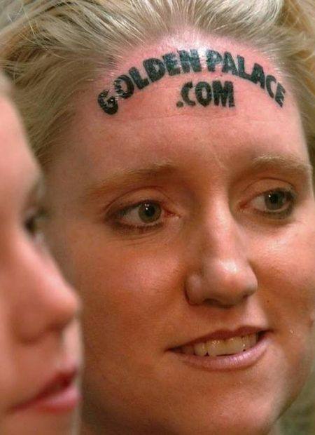 Women's GoldenPalace.com forehead tattoo
