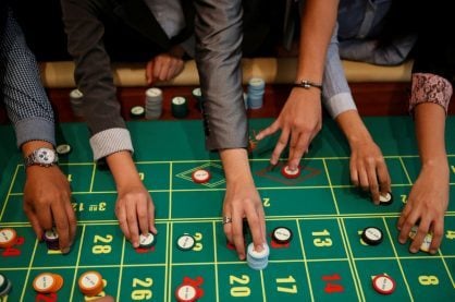 Gamblers placing their bets at a roulette table