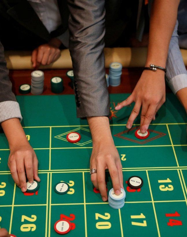 Gamblers placing their bets at a roulette table