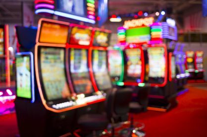 Blurred Slot machines in a casino.