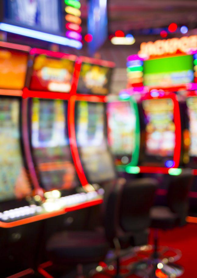 Blurred Slot machines in a casino.