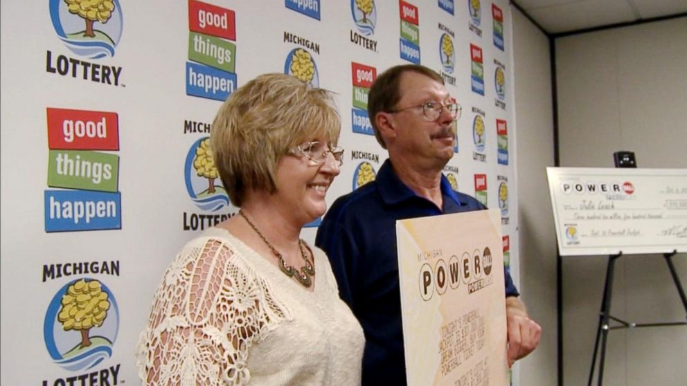 Lottery winners posing with their winning ticket/numbers