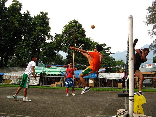 Players playing Sepak Takraw on an outdoor court
