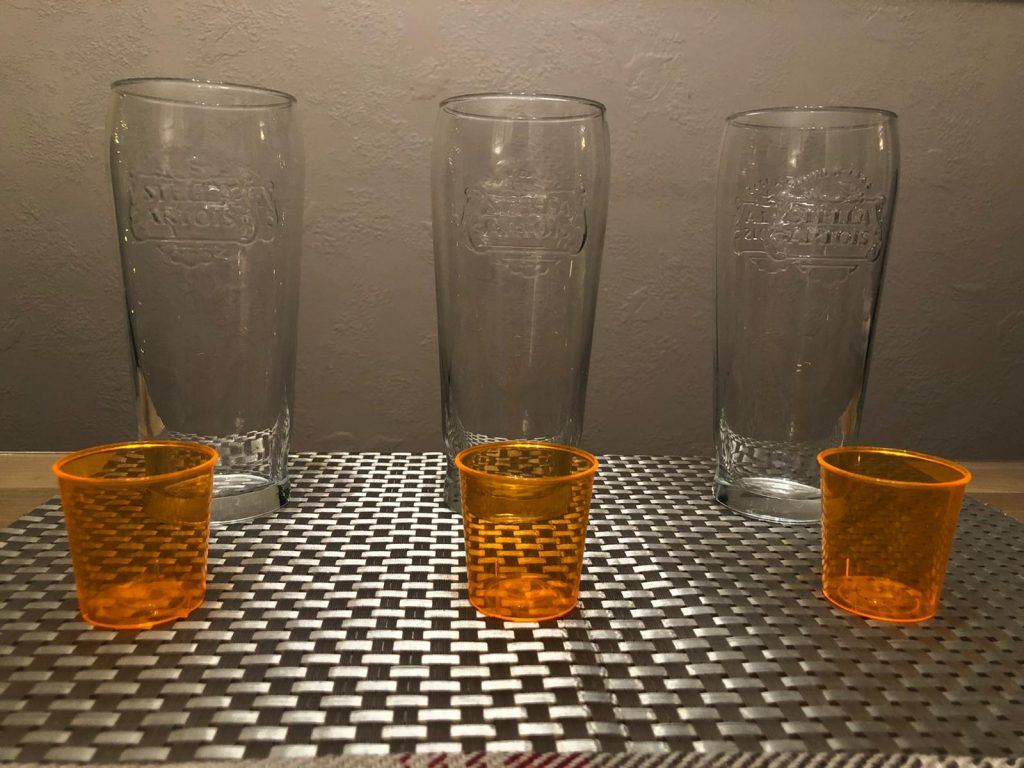 Three pint glasses and three shot glasses