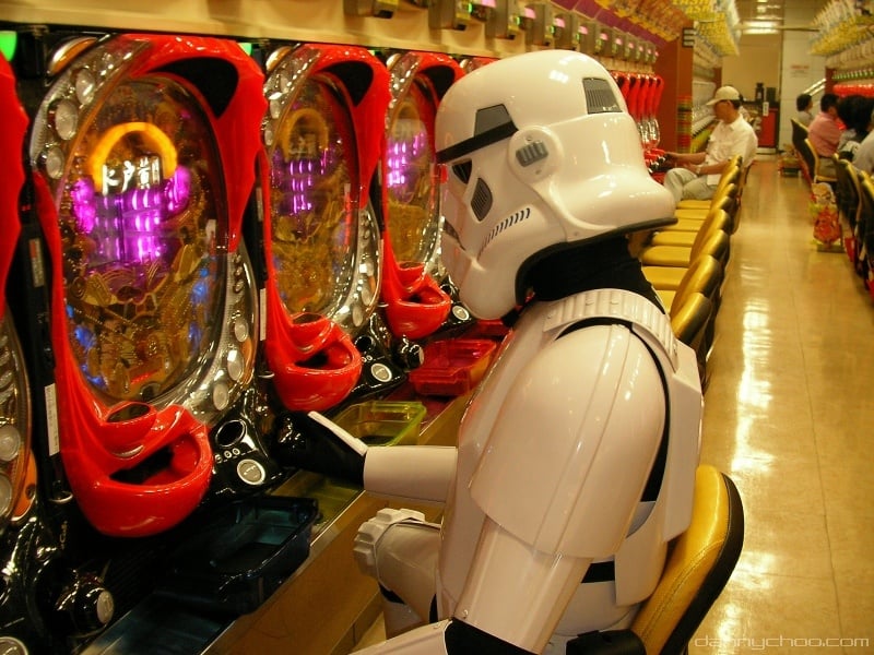 player in storm trooper costume plays a pachinko machine