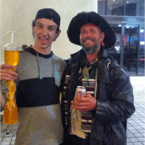 A drunken guy taking a picture with a Pirate impersonator