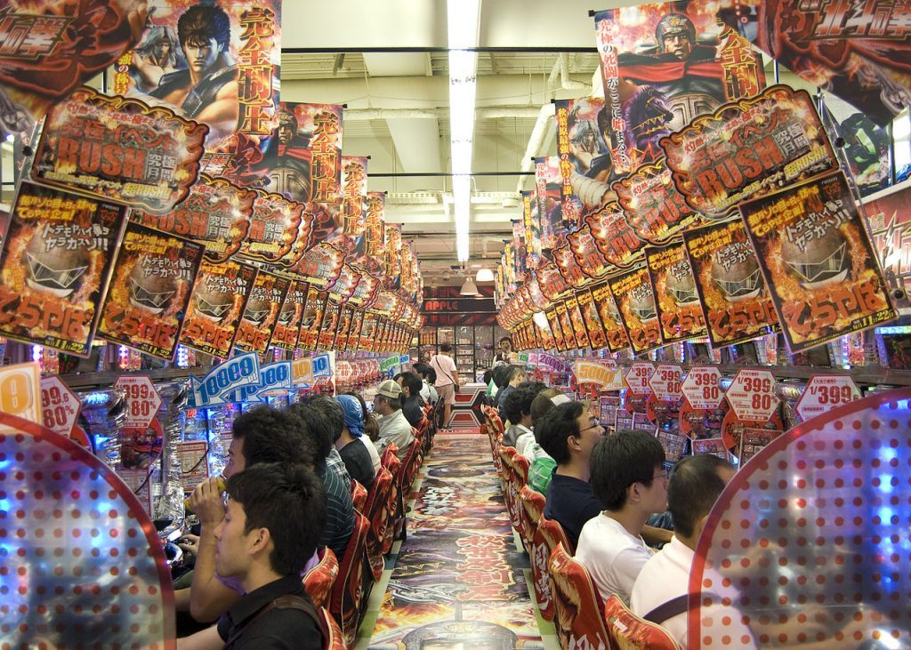 photo showing players inside a pachinko parlor playing on machines
