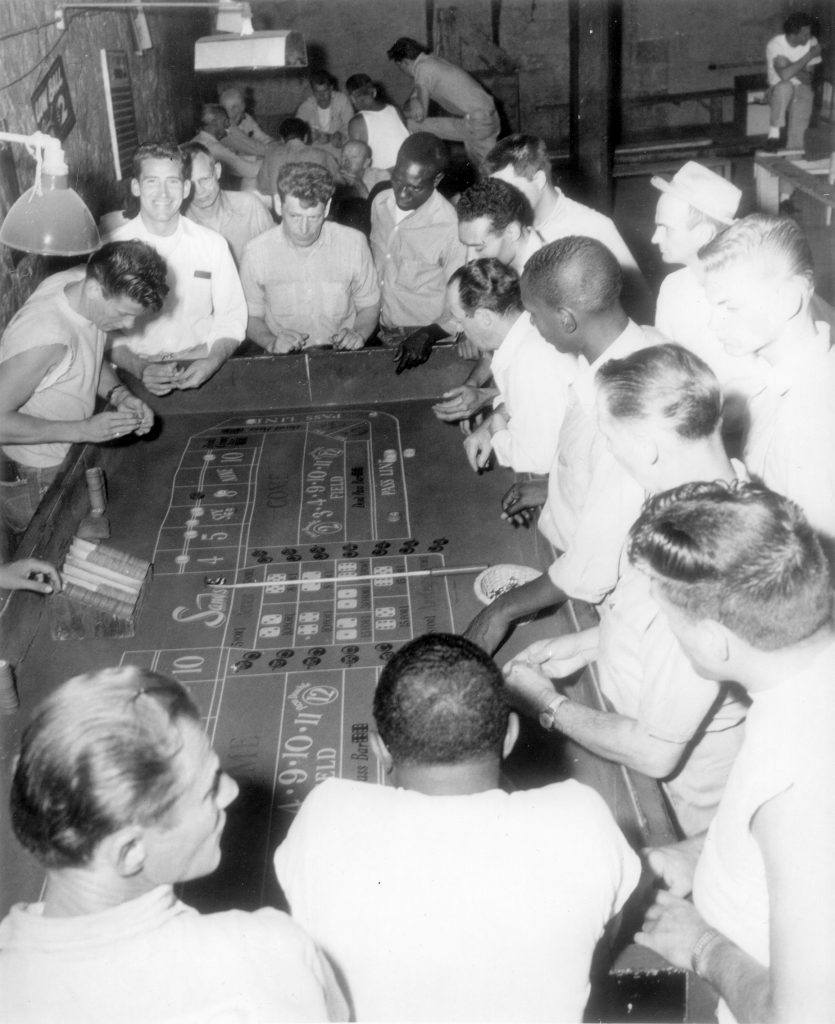 Prisoners enjoying a table game from the in-house casino