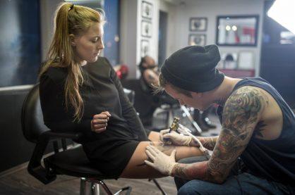 A woman getting a tattoo done