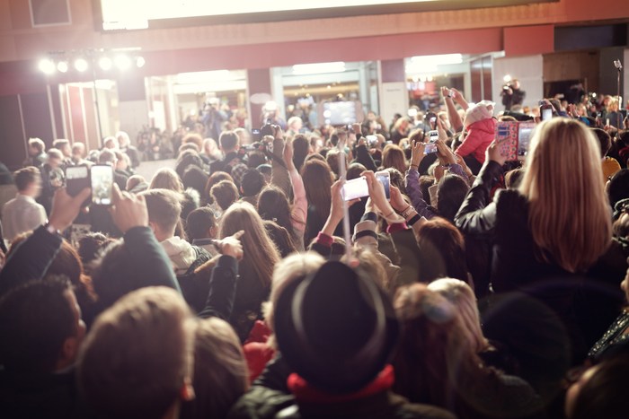 A crowd gathering to take photos of celebrities