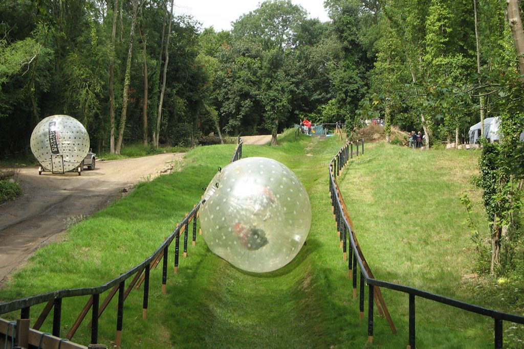 Thrill seekers enjoying a Zorbing course