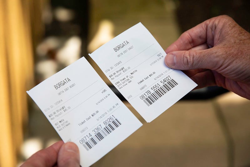 Person holding bet slip