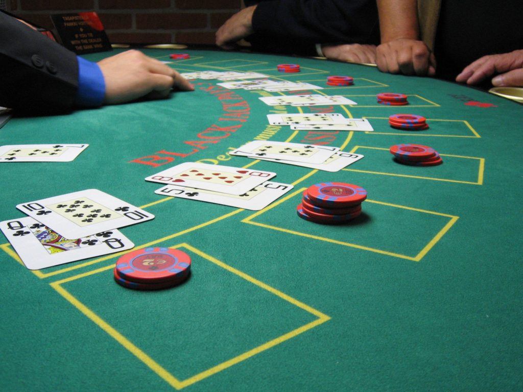 Blackjack hands being played on a standard casino table