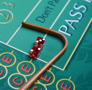 Dice and stick on craps table