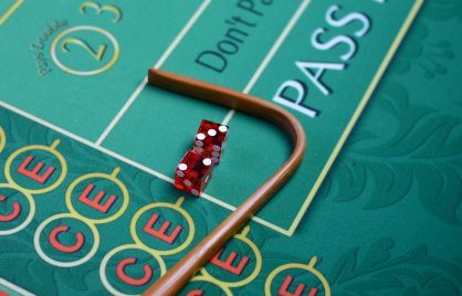 Dice and stick on craps table