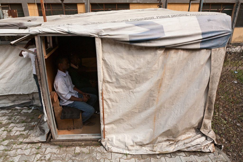 man in hut playing game in Nigeria