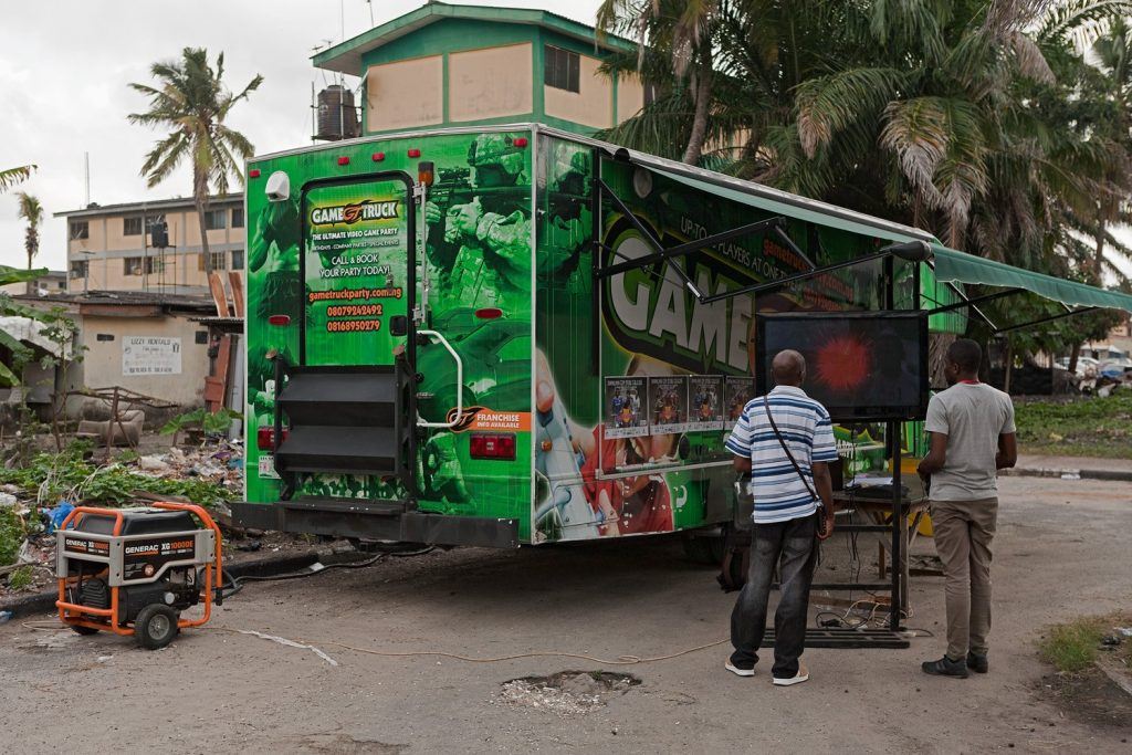 Gamers stand outside a mobile esports truck in Nigeria
