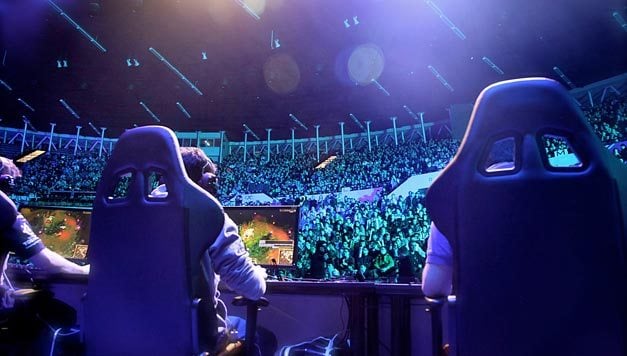 professional esports players playing in front of fans