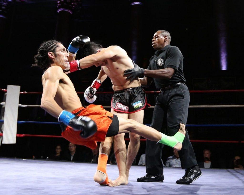 a muay thai referee with fighters