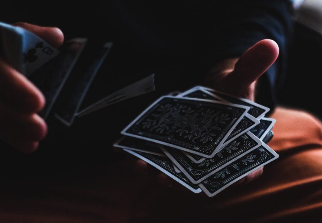 man shuffling blackjack playing cards