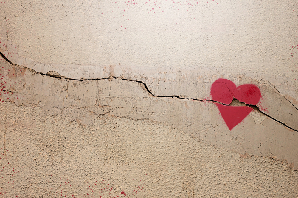 A heart painted on a cracked wall.