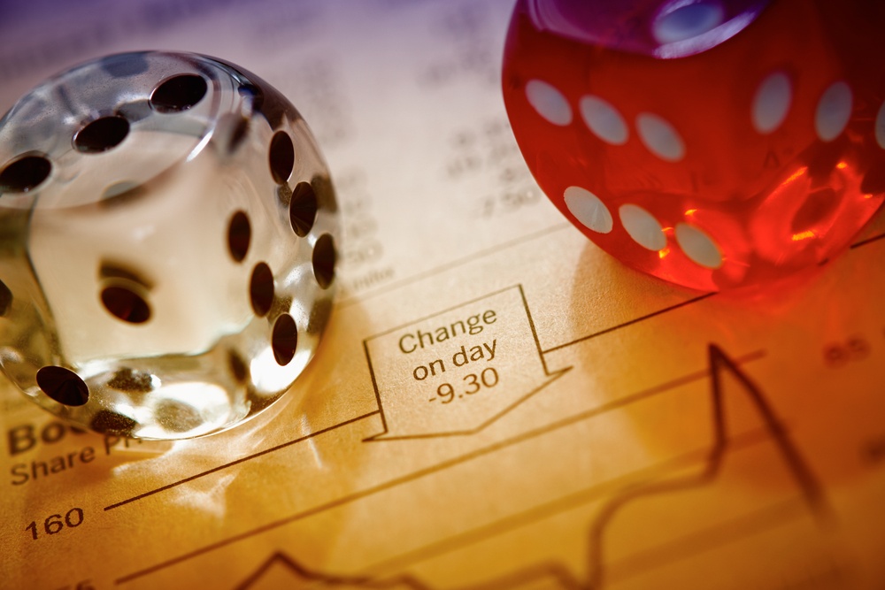 Dice on stocks and shares sheet