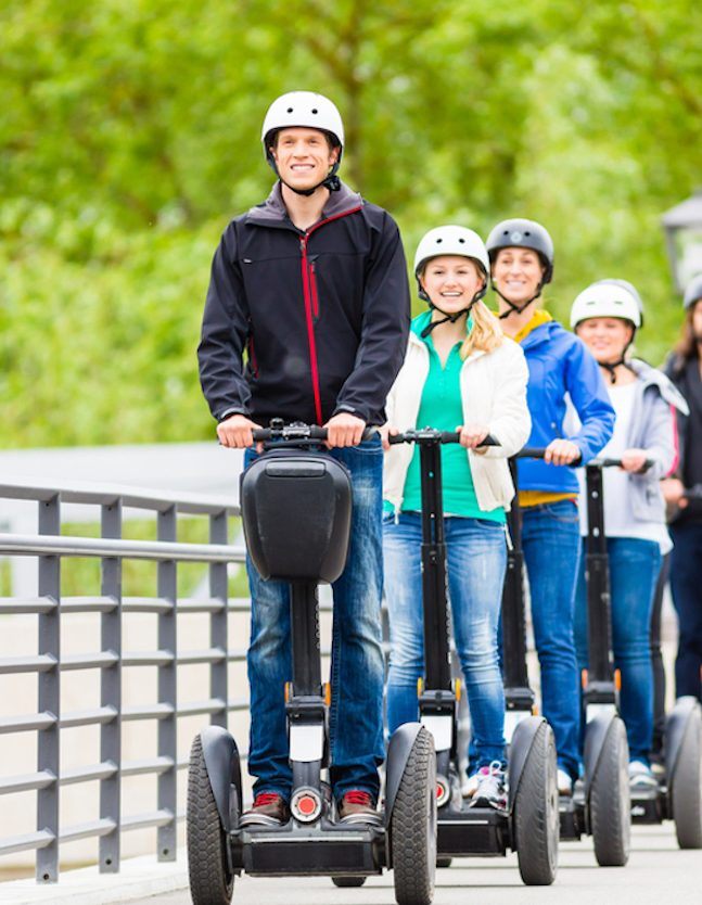 Tourist group having guided Segway city tour
