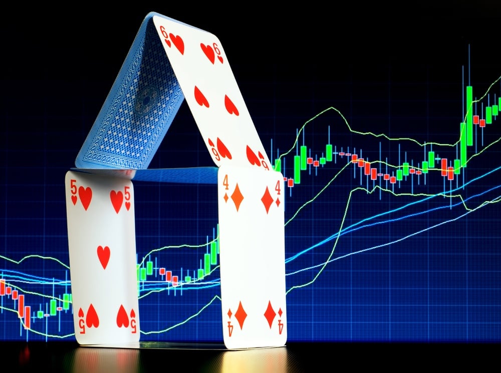 Stocks chart with playing cards in front of it