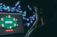 Woman playing online poker late at night