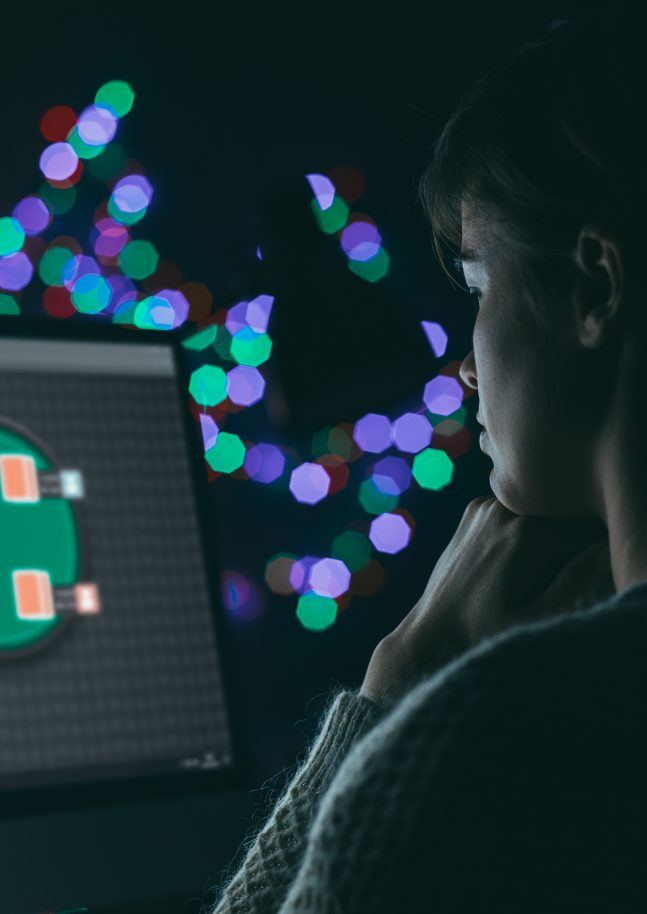 Woman playing online poker late at night