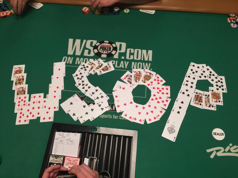 'WSOP' written in playing cards on a poker table