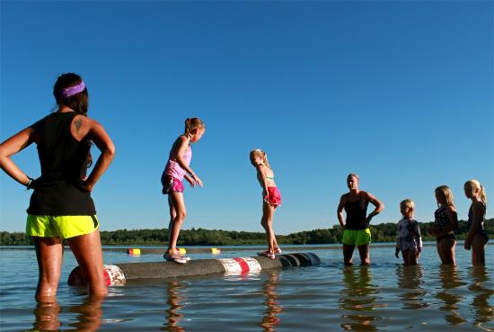 kids balancing on logs