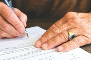 Mann unterschreibt Vertrag