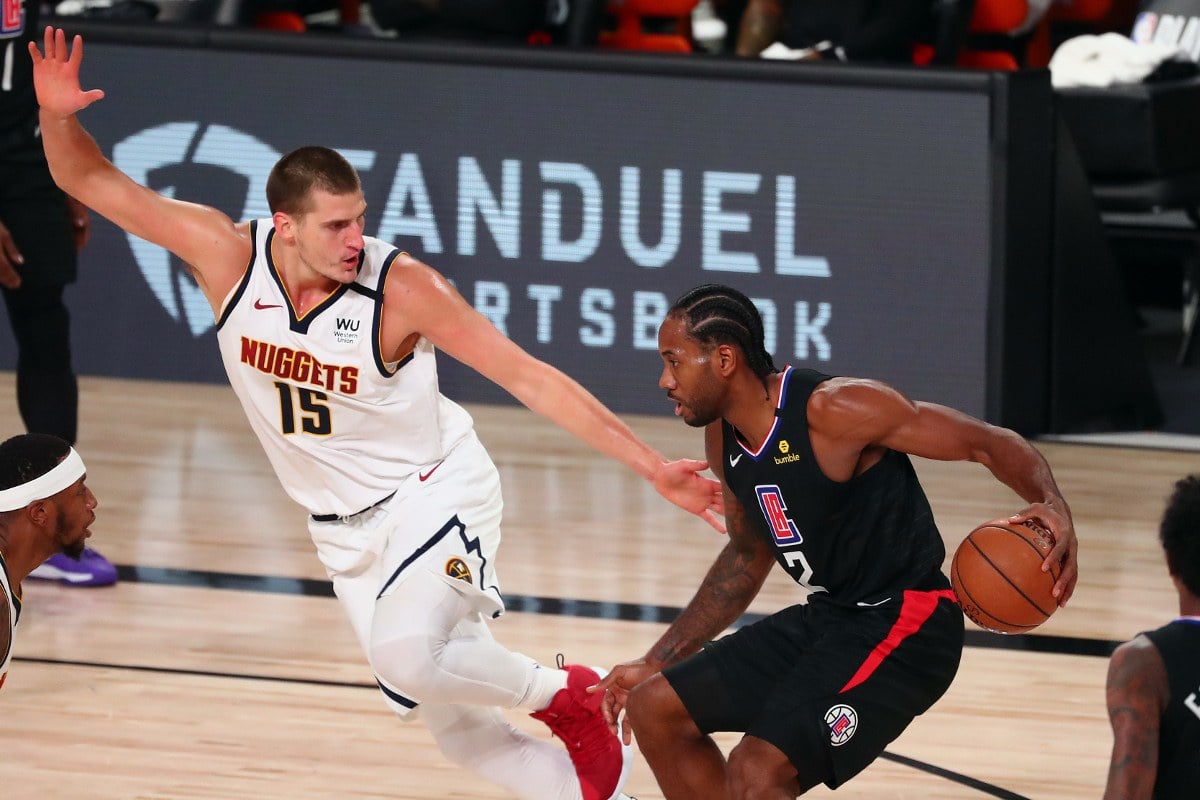 Kawhi Leonard drives against Nikola Jokic.