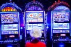 A woman plays an IGT slot machine.