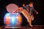Magician Dirk Arthur performs with a snow leopard in this undated photo from his website. 