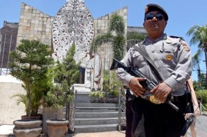 A police officer stands at the memorial of the 2002 Bali bombing site in Bali, Indonesia