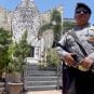 A police officer stands at the memorial of the 2002 Bali bombing site in Bali, Indonesia