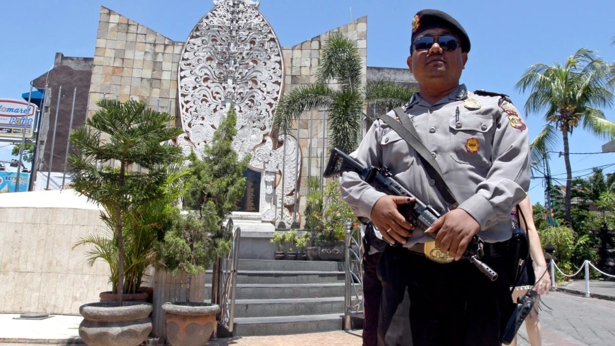 A police officer stands at the memorial of the 2002 Bali bombing site in Bali, Indonesia