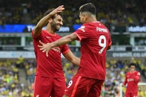 Liverpool’s Mohamed Salah and Roberto Firmino celebrate a goal